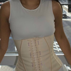 Woman wearing the Snatched Faja Waist Trainer in beige, front view